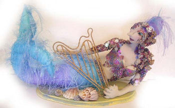 With a tail made of eyelash fabric, this gorgeous 13" reclining mermaid is