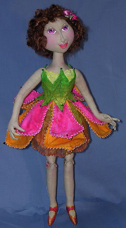 18” flower fairy has button jointed legs, needle sculpted features and a costume fashioned from wired and beaded petals.