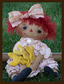 This darling 18” raggedy is all ready for Easter with her “Peeps!” 