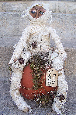 Fantastic 16” mummy wrapped in cheesecloth with spiders cleverly made from rusty jingle bells and wire. 